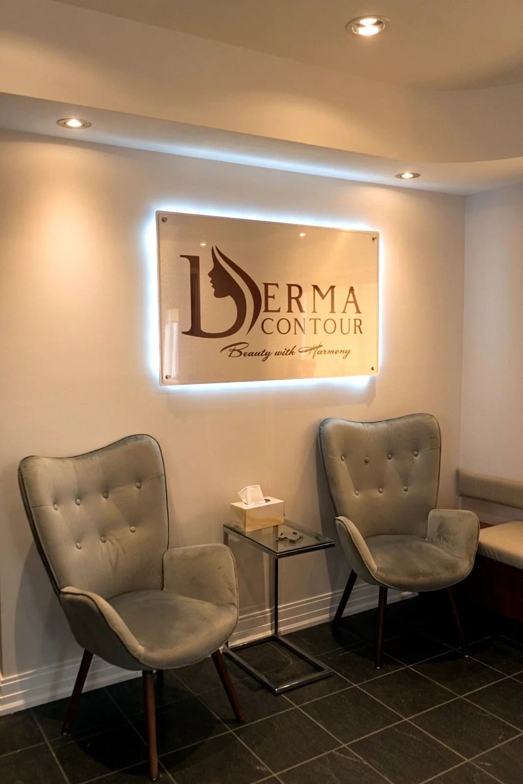 Illuminated Derma Contour logo wall in the lounge
